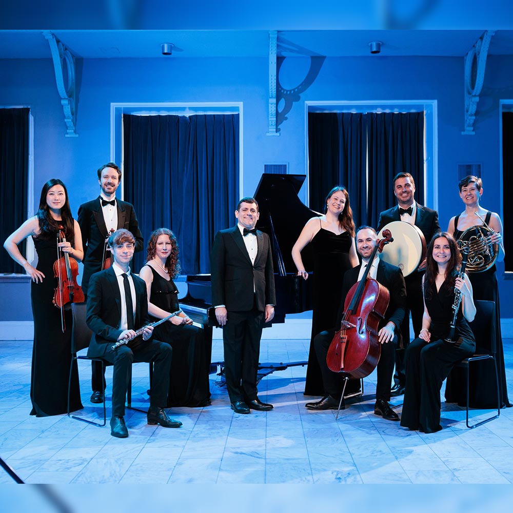 Group Photo of Juventas New Music Ensemble with members holding their instruments